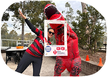 Students including one in a dinosaur costume having fun at a Jump Rope for Heart school event