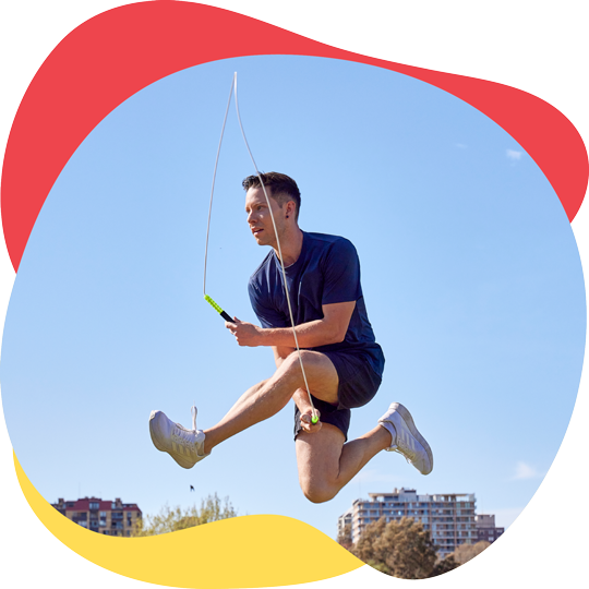 Luke Boon, jumping over a skipping rope with a criss cross movement Two young primary school girls skipping next to each with skipping ropes