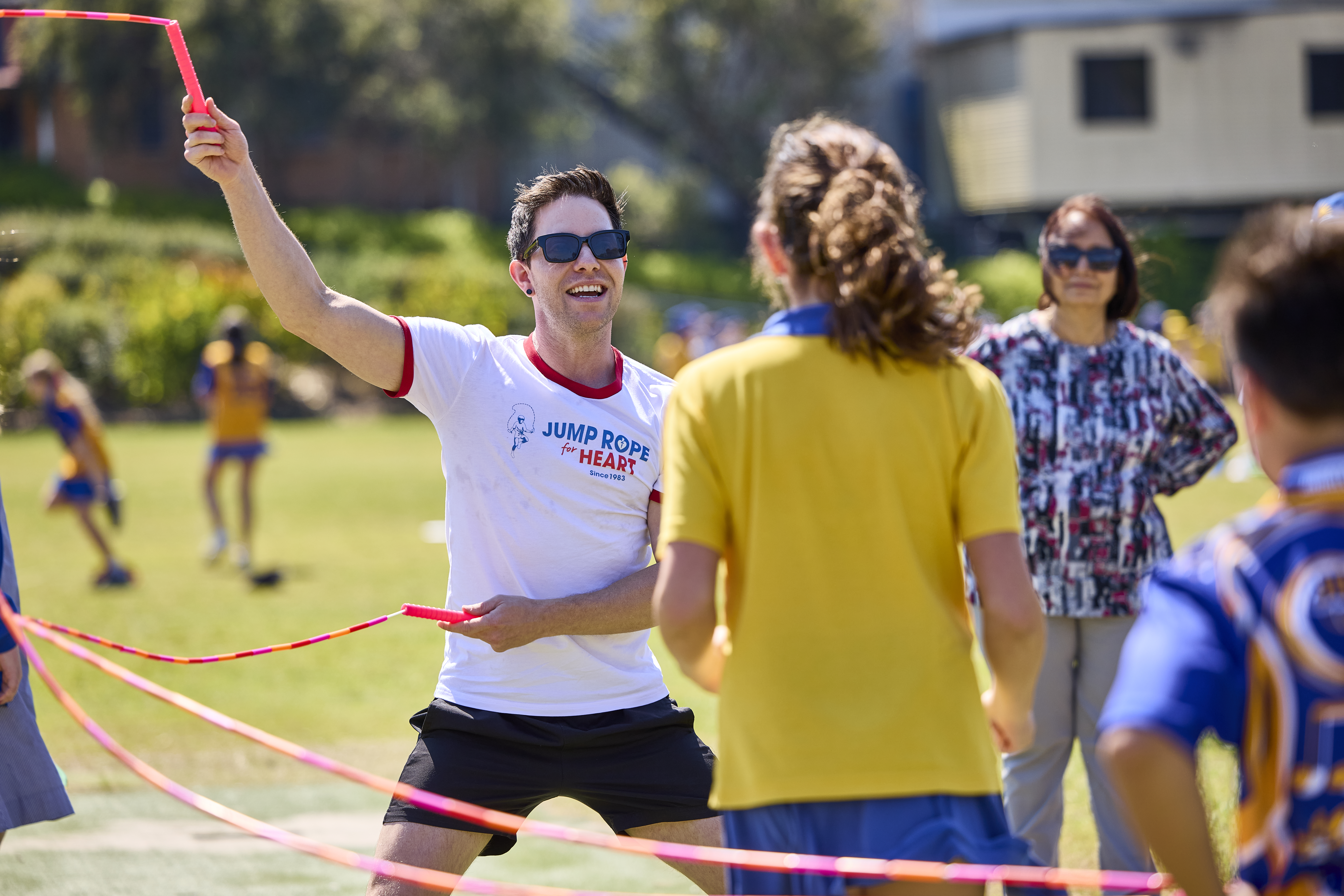 as skipping instruct smiling and having fun with his class of kids