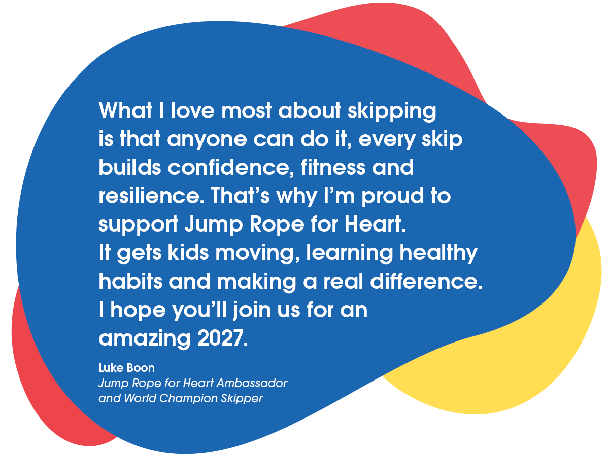 A young smiling girl skipping over a long skipping rope being turned by a Heart Foundation Jump Rope for Heart field officer.
