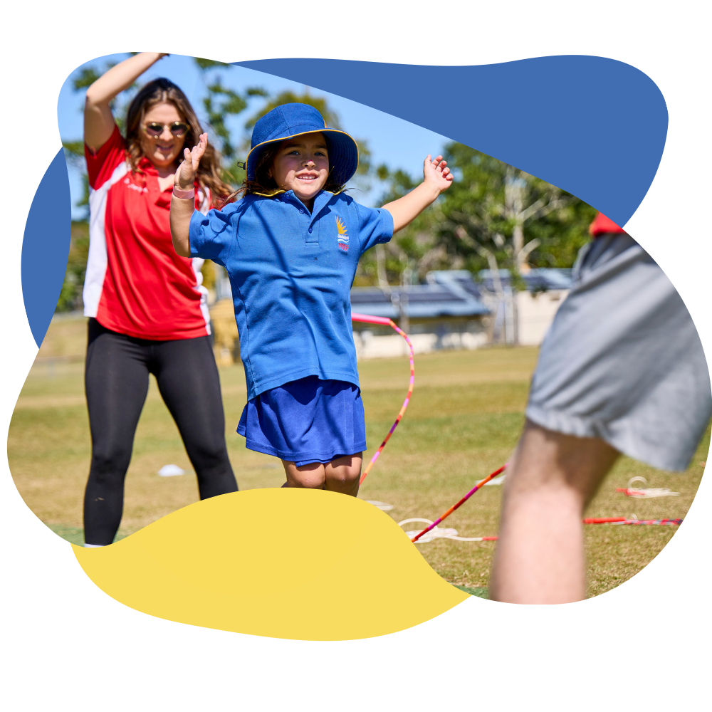 A Jump Rope for Heart Field officer helping a student jump over a long skipping rope