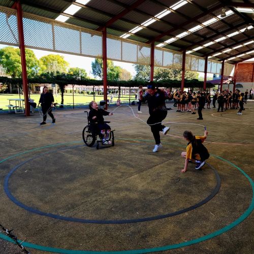 A young child using a wheelchair participating in the Jump Rope for Heart program
